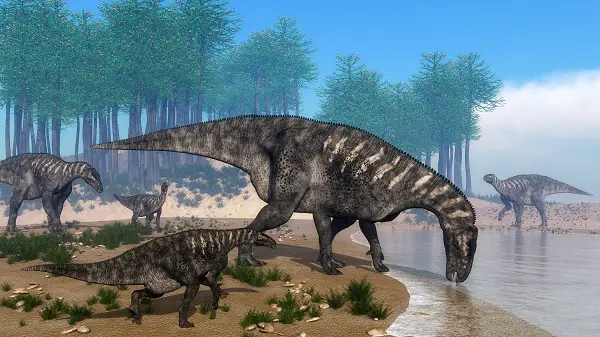 Iguanodon,Dinosaurs,Herd,Walking,At,The,Shoreline,In,Front,Of